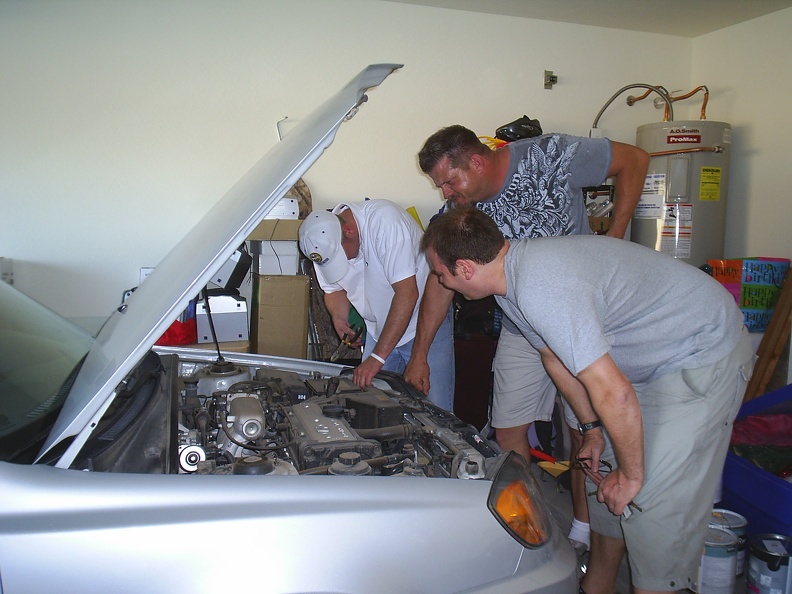 3 men to get a car battery out 